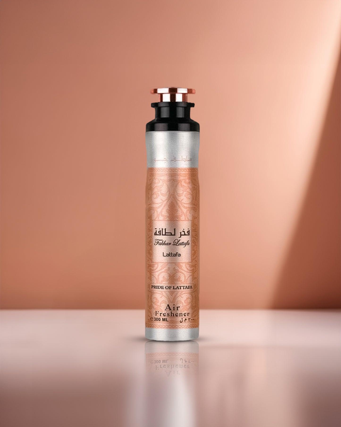 lattafa fakhar Rose air freshener bottle with metallic design on a peach background