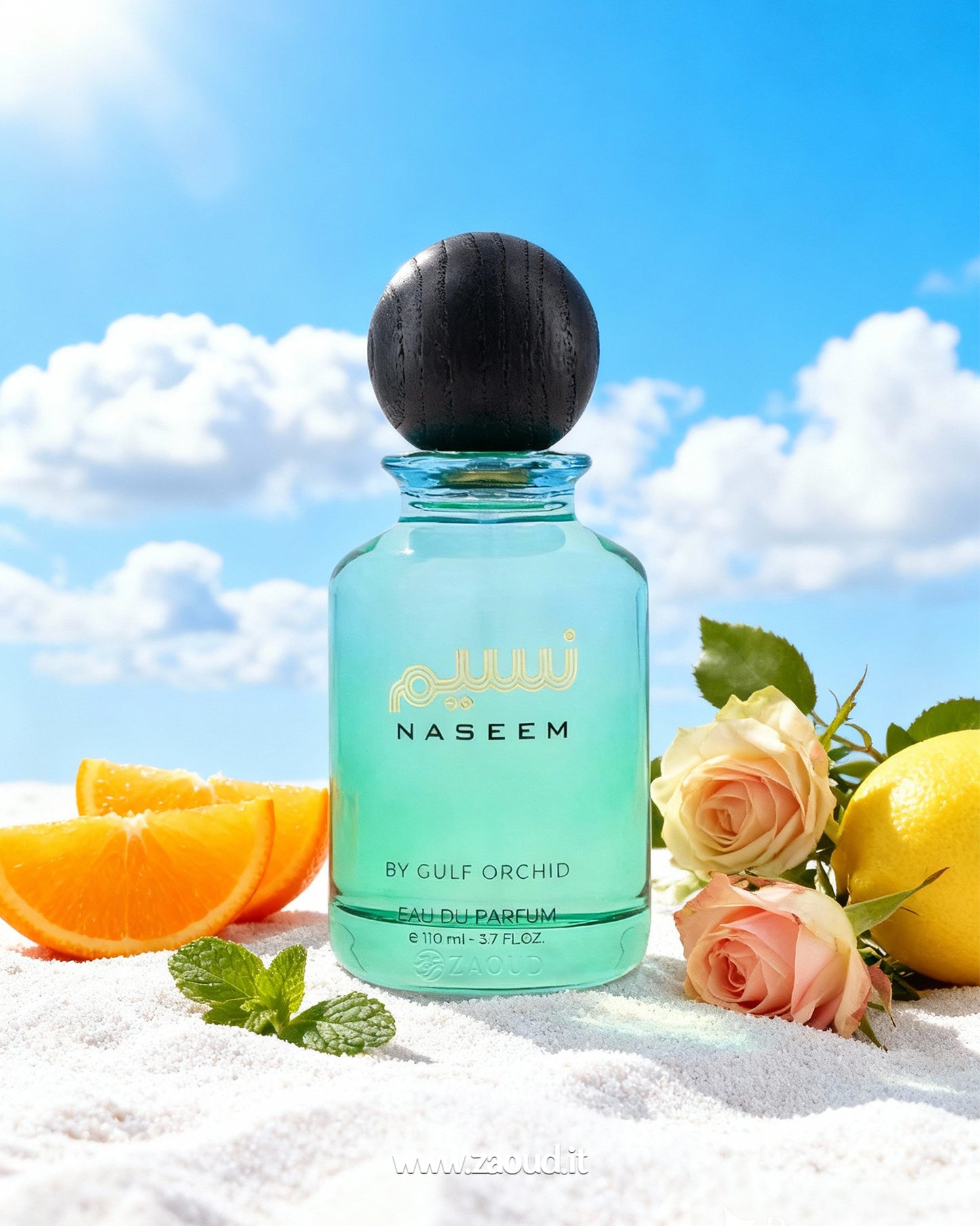 Naseem by Gulf Orchid perfume bottle with oranges, lemons, and roses on a sandy background