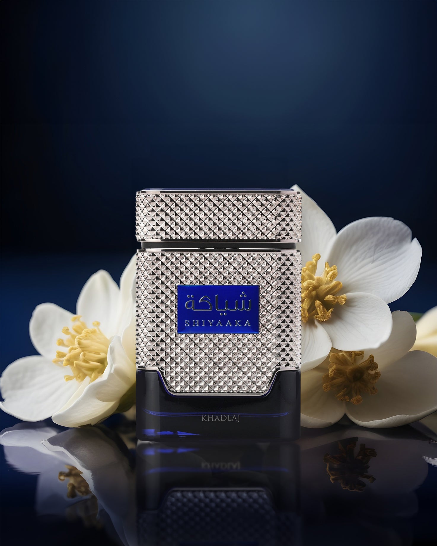 SHIYAAKA BLUE perfume bottle photograph besides white flowers