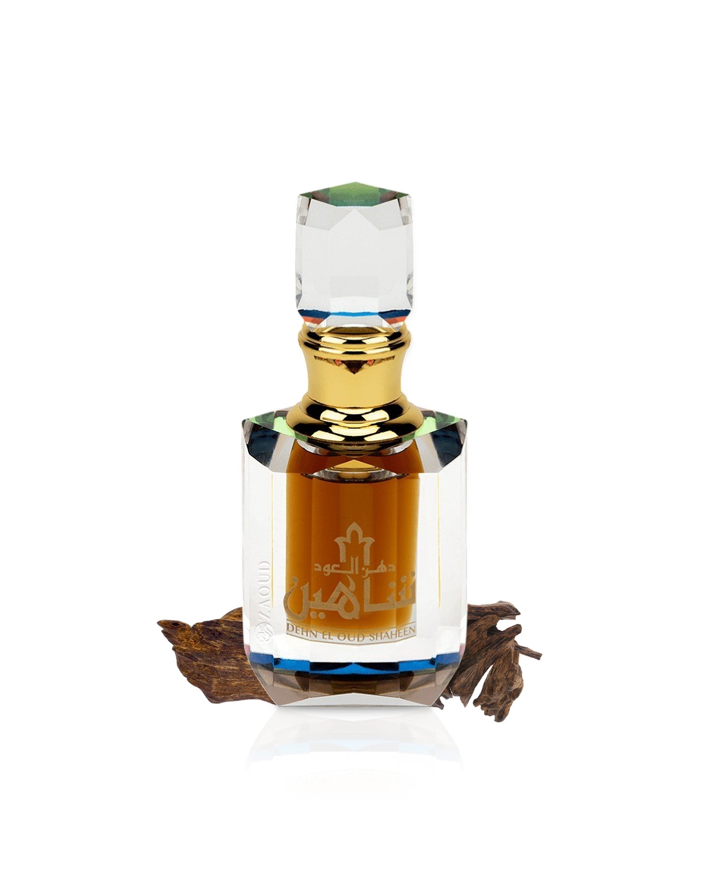 Dehn el oud shaheen perfume oil bottle with gold cap with behind agarwood chip on a white background
