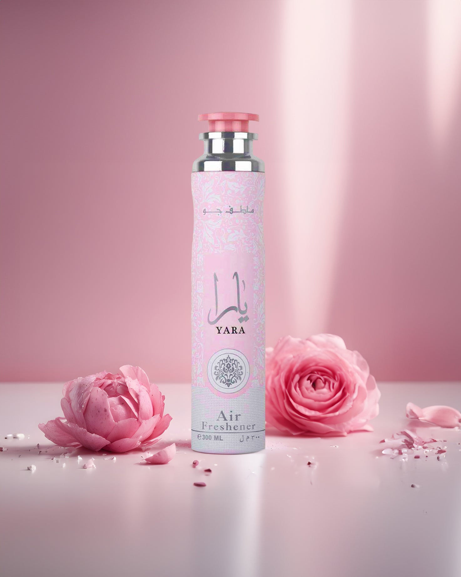 Yara AIR FRESHNER BOTTLE surrounded by roses against pink background with sunlight