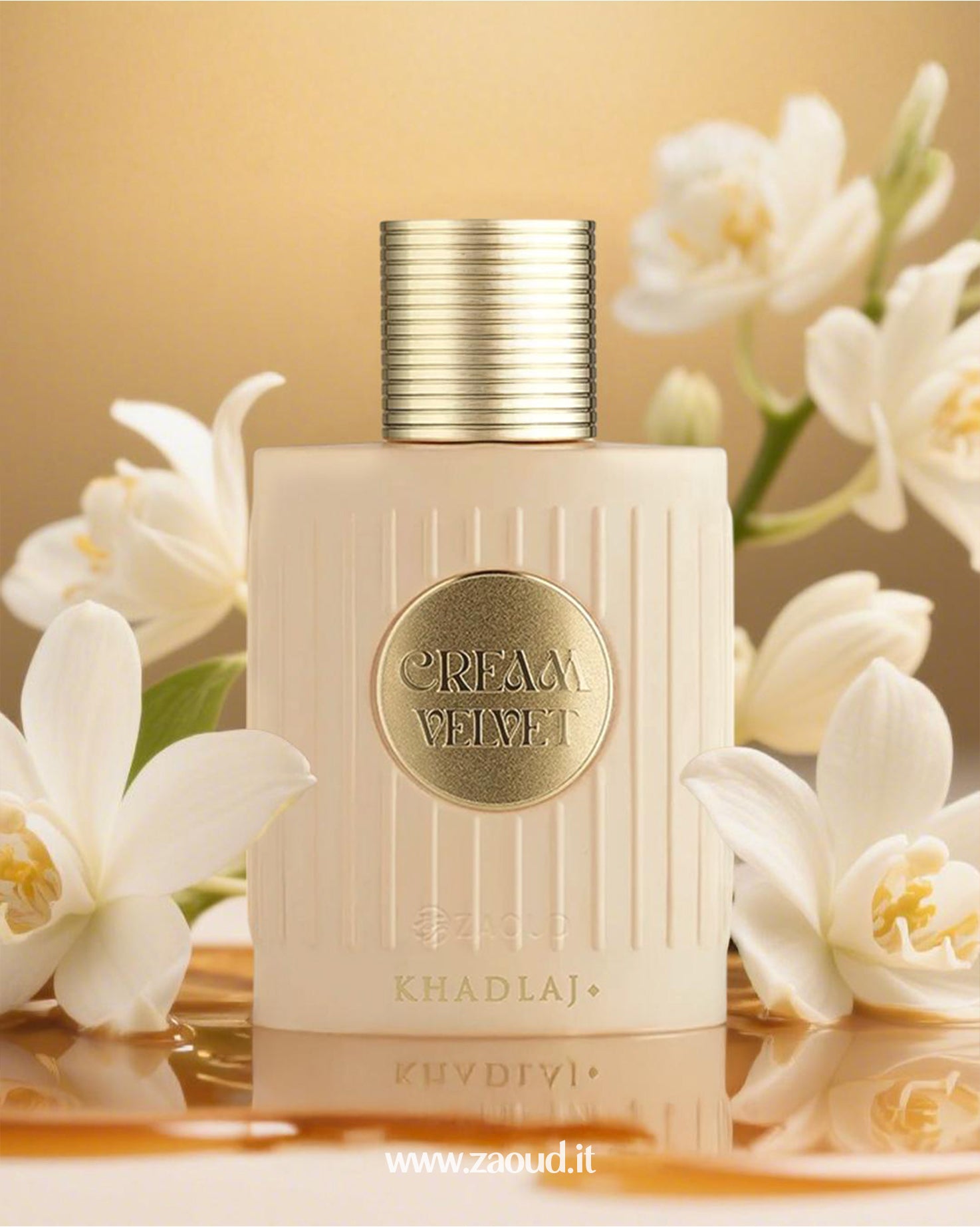 Khadlaj Cream Velvet luxury perfume bottle with gold accents, featuring a refined design surrounded by white flowers and a soft golden background.