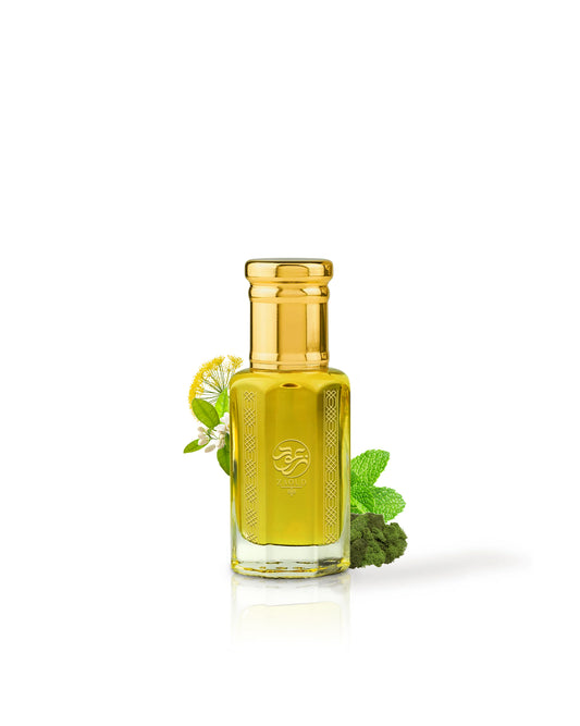 eden hut perfume oil bottle filled with golden yellow liquid, topped with a shiny gold cap, styled with mint leaves and a small white flower on a clean white background.