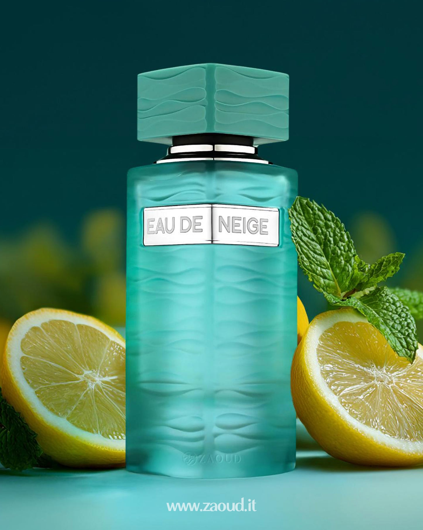 Turquoise perfume bottle of Vulcan Feu by French Avenue, decorated with a golden snake, surrounded by mango slices, lemon, ginger root, and white flowers, on a matching turquoise background.