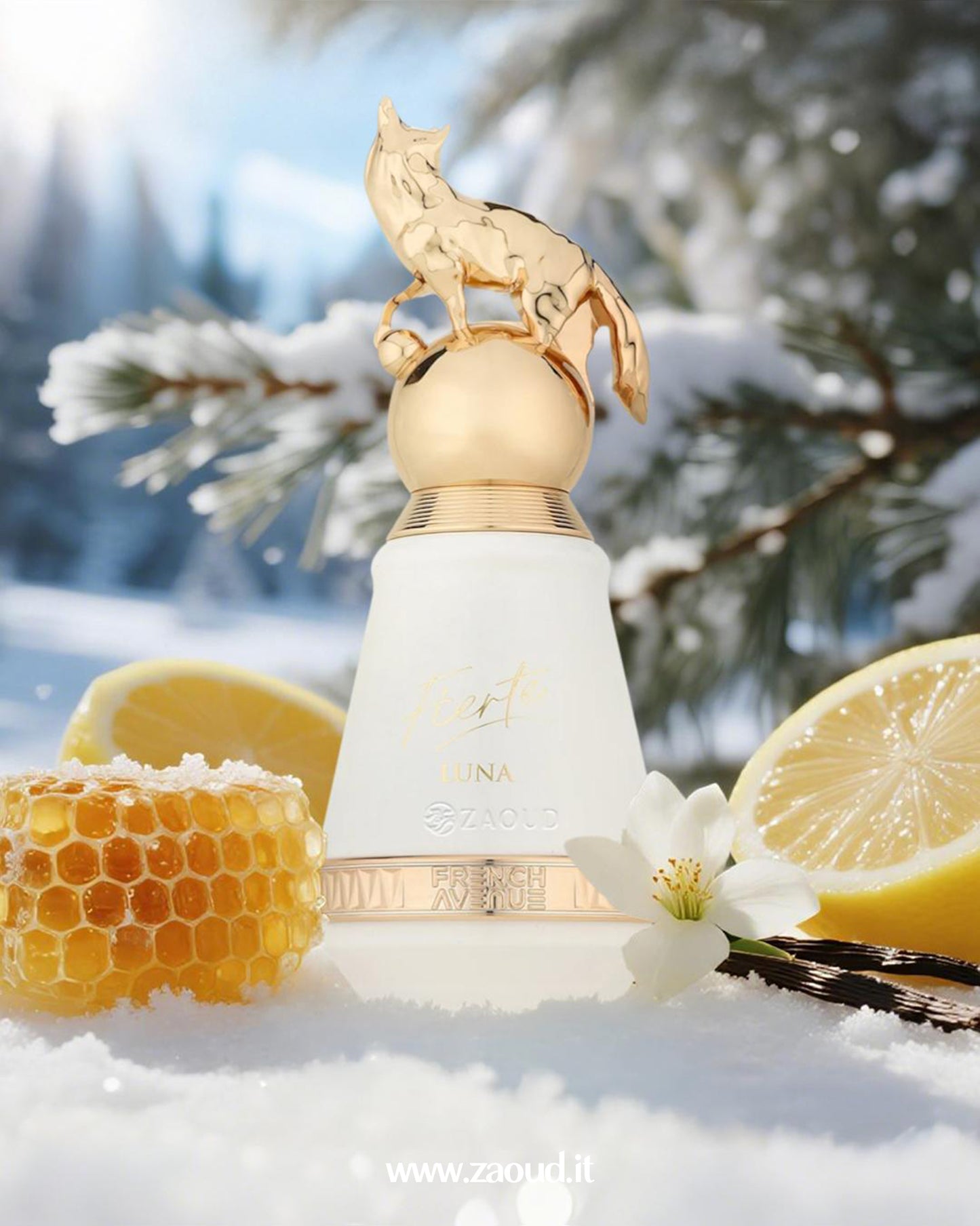 Fierte Luna by French Avenue, topped with a golden fox figurine, set in a snowy scene with lemon slices, a honeycomb, vanilla beans, and a white flower.