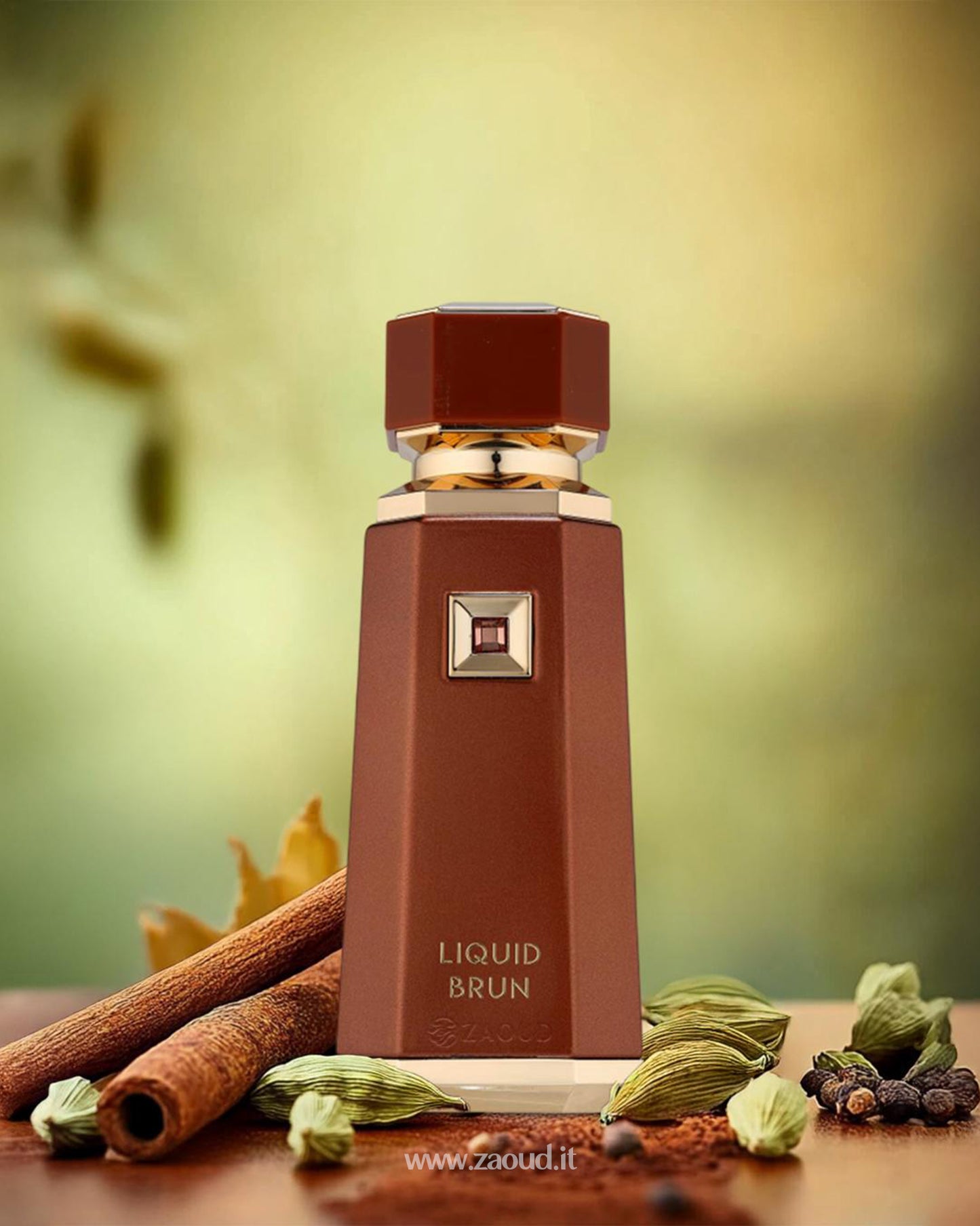 french avenue liquid brun perfume bottle photograph beside cinnamon stick and cardamom against blurry background