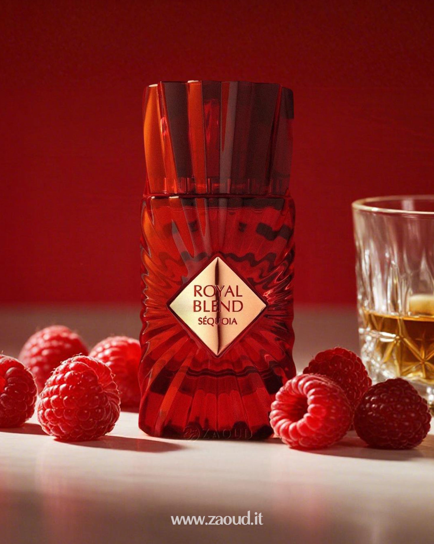Red bottle labeled 'Royal Blend sequoia' with raspberries and a glass of liquid on a red background