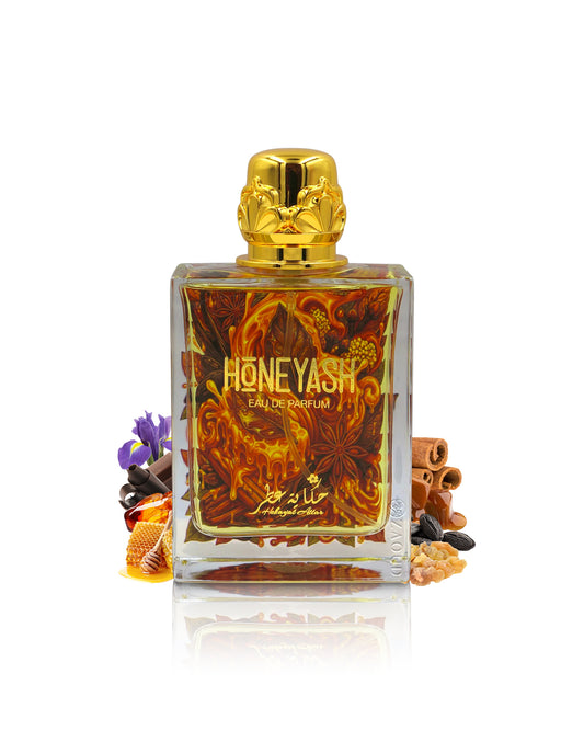 hekayat attar honeyash perfume bottle surrounded with fragrance notes like honey and spices shows against white background