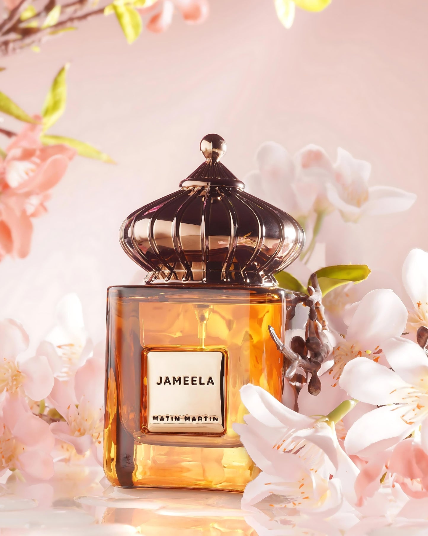 Perfume bottle labeled 'Jameela' by Matin Martin with floral background