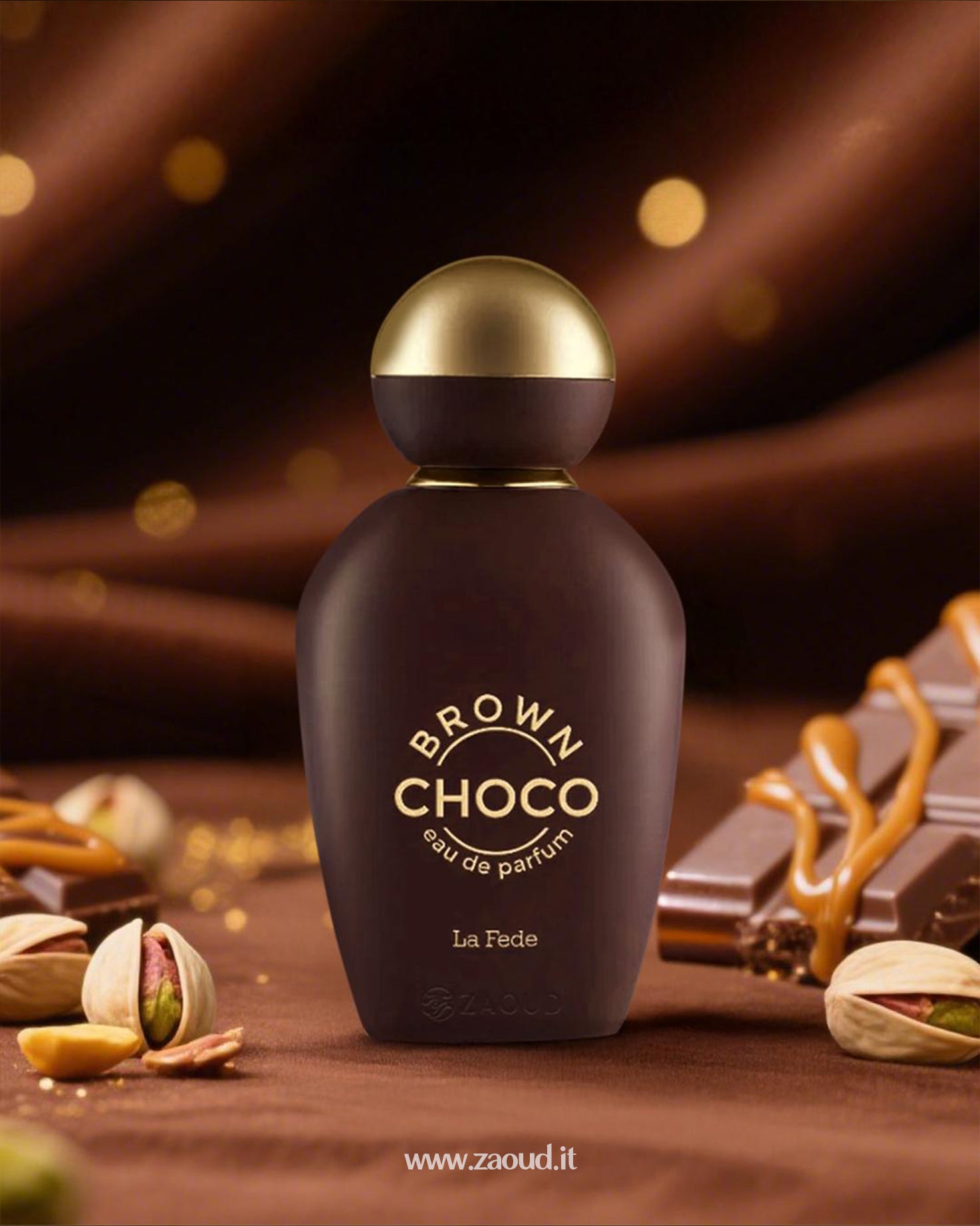 Khadlaj Brown Choco perfume bottle surrounded by chocolate, caramel, and pistachios shows besides with blurry background