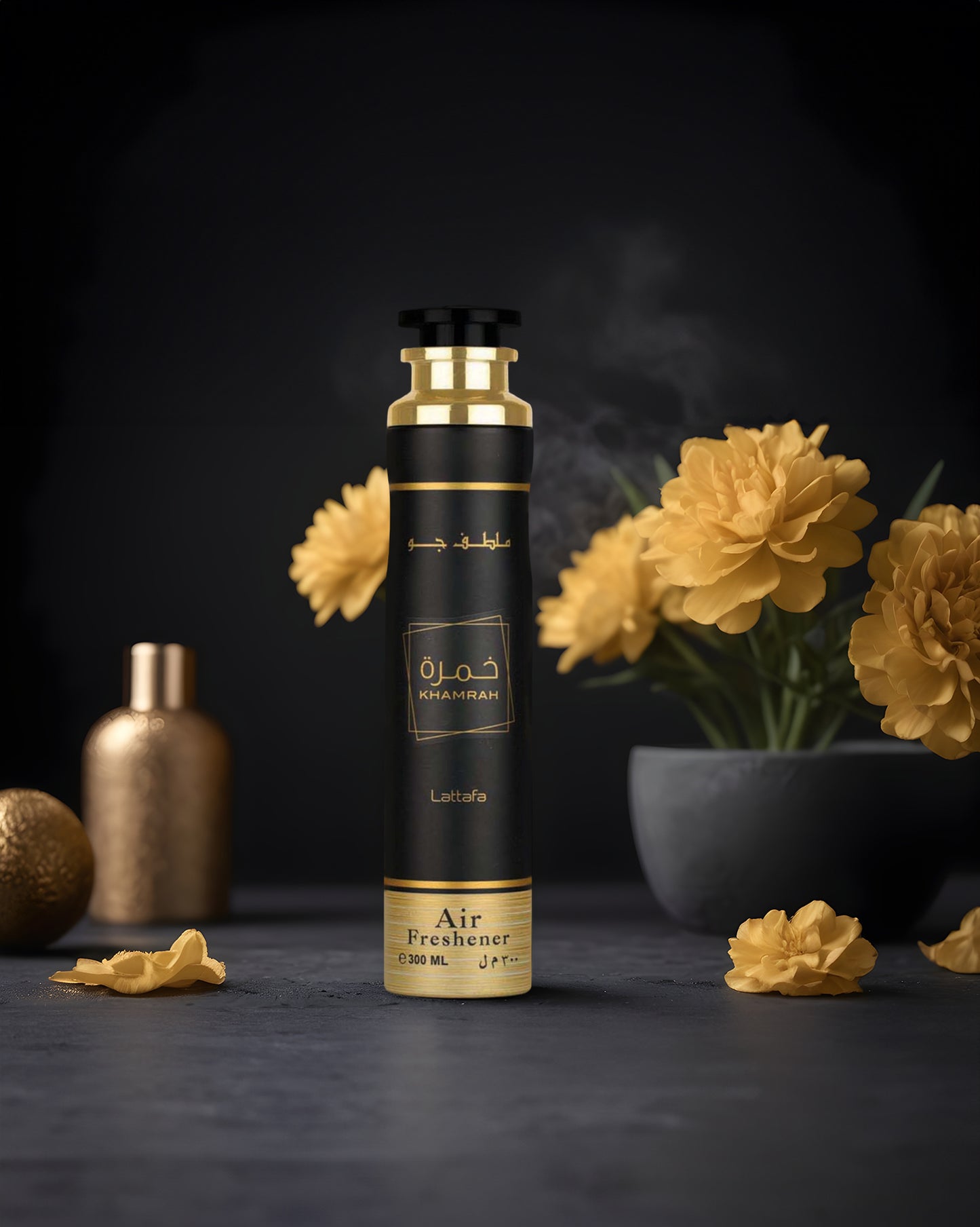 khamrah air freshener bottle photograph inside dark room with yellow flower at background
