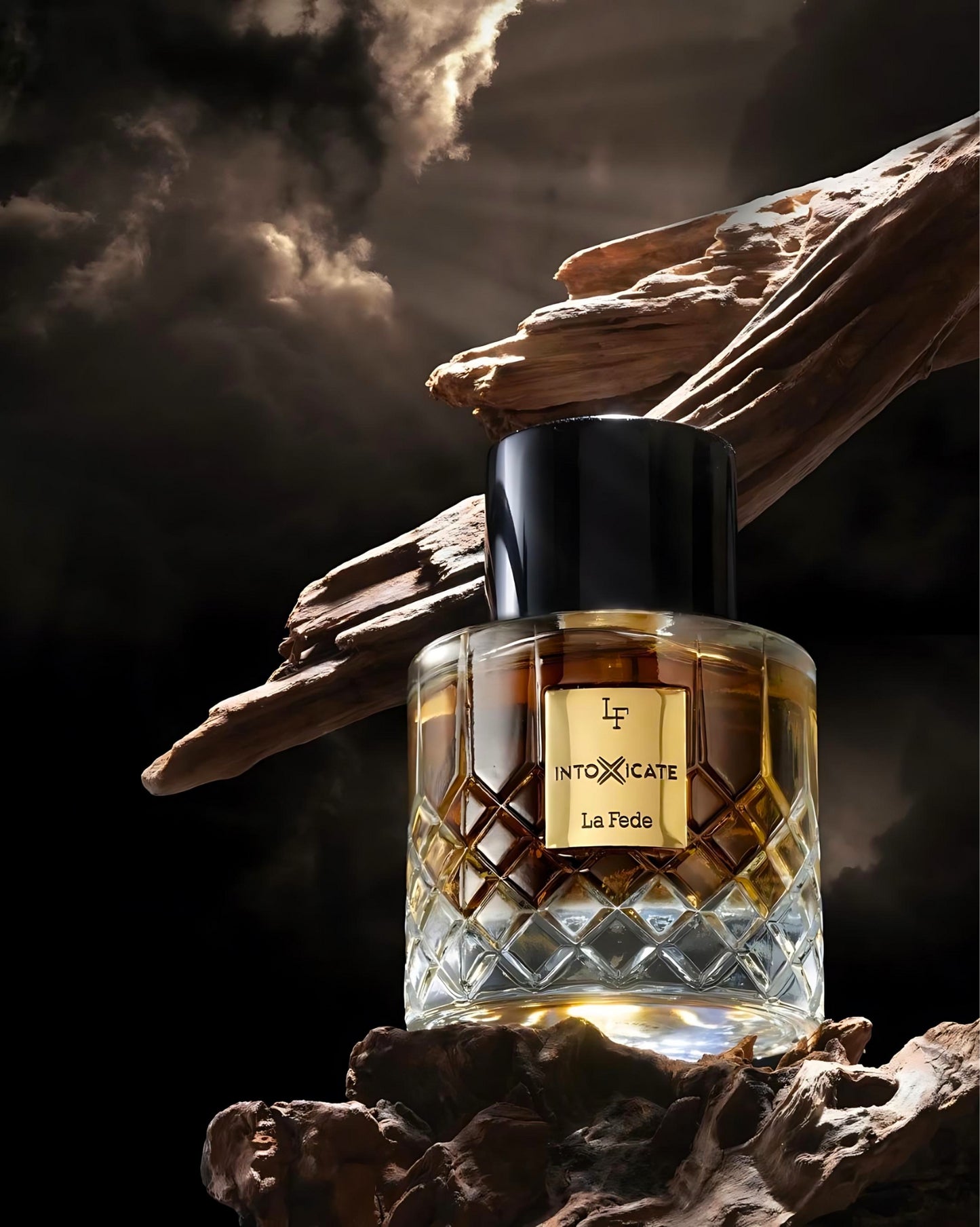 la fede Intoxicate eau de parfum perfume bottle photograph over woodlog against cloudy sky