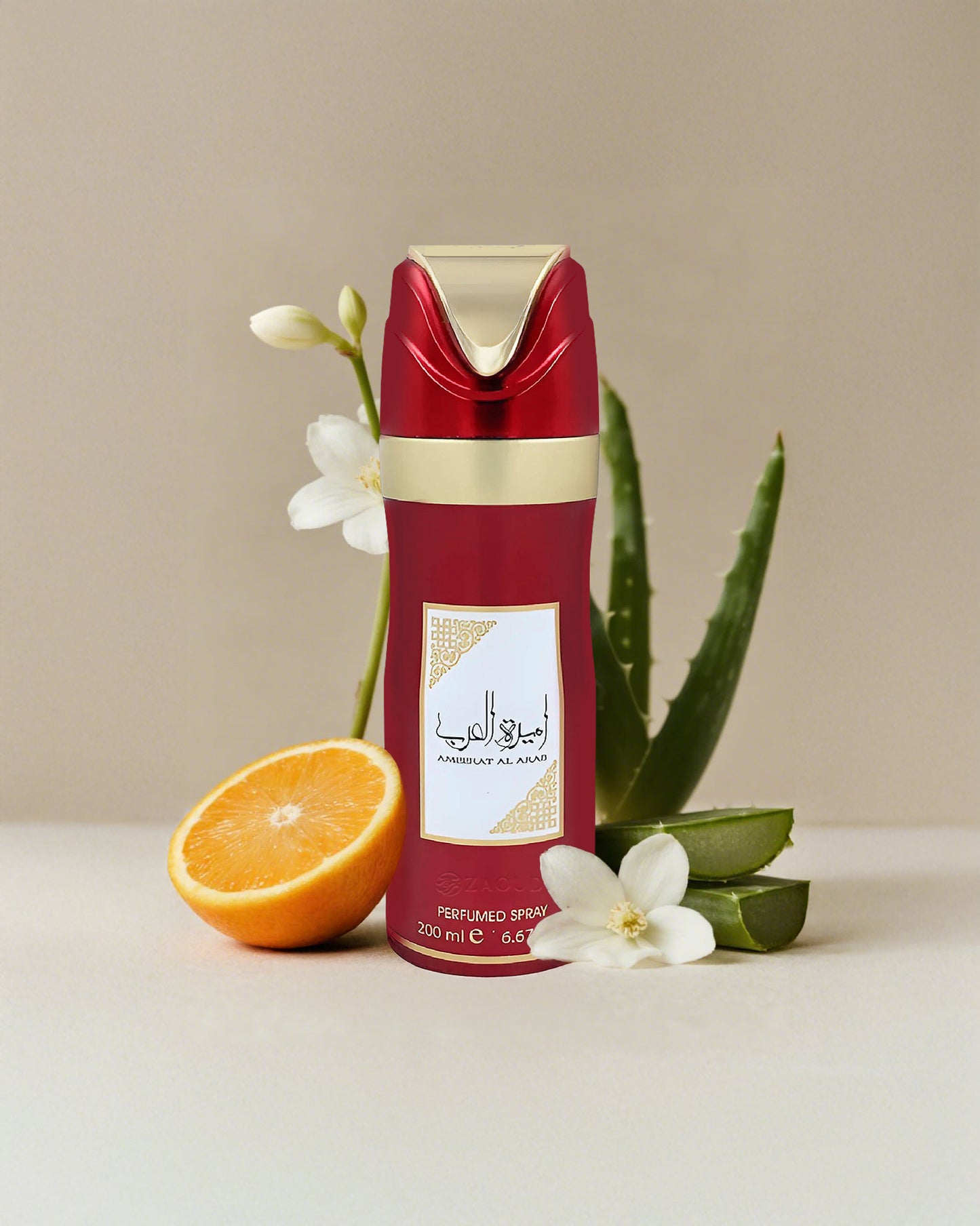 lattafa ameerat al arab deodorant Red and gold perfume bottle with orange, aloe vera leaves, and flowers on a beige background