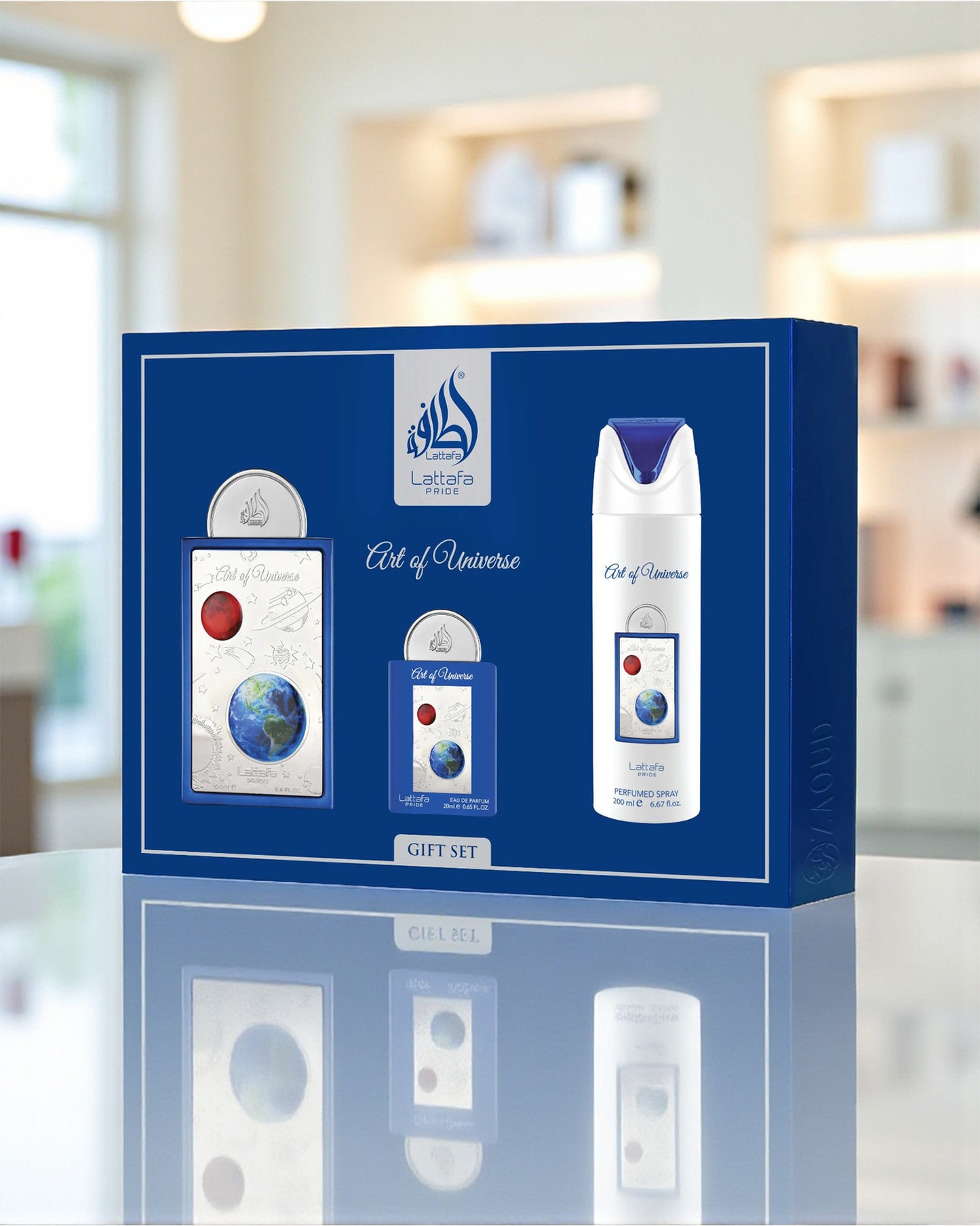 lattafa art of universe gift set packaging on a reflective surface with a blurred indoor background
