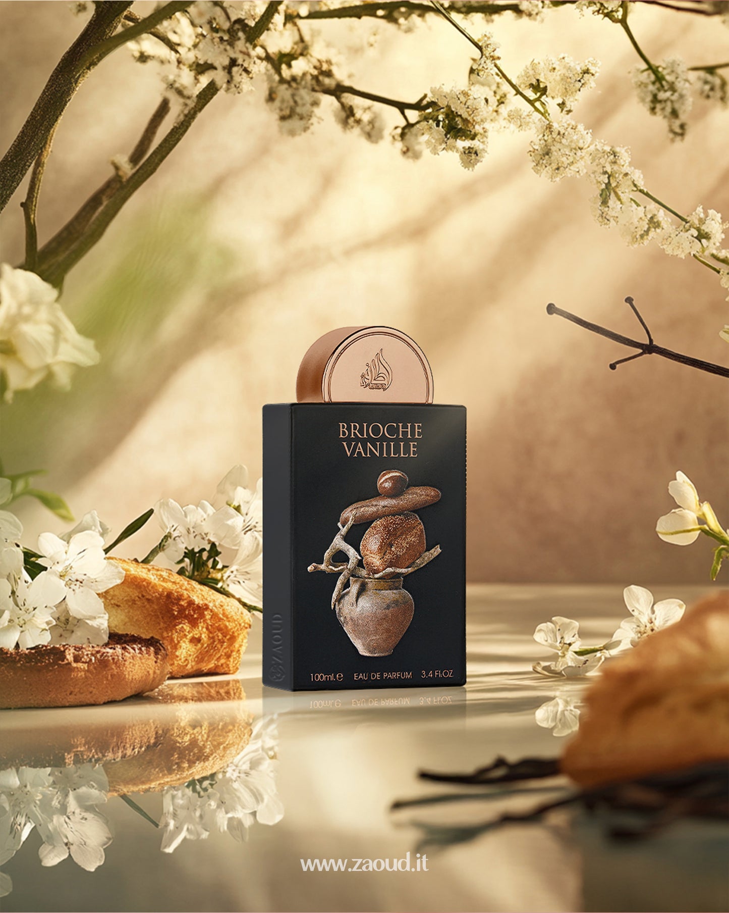 lattafa brioche vanille perfume bottle photograph over reflected surface beside btioches and white flowers