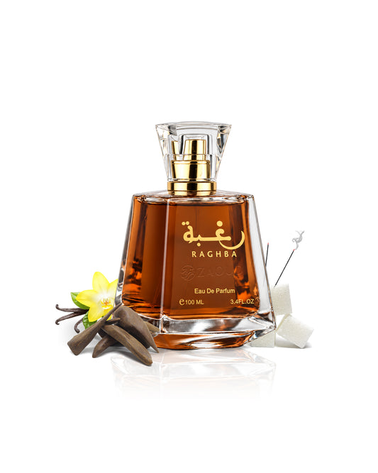 lattafa raghba perfume bottle with amber liquid, gold lettering, and a clear cap, styled with vanilla beans, a yellow flower, and a sugar cube on a white background.