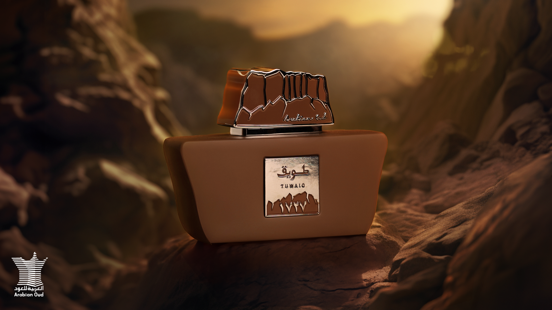 Arabian Oud tuwaiq perfume bottle over top of mountain aginst sunset.