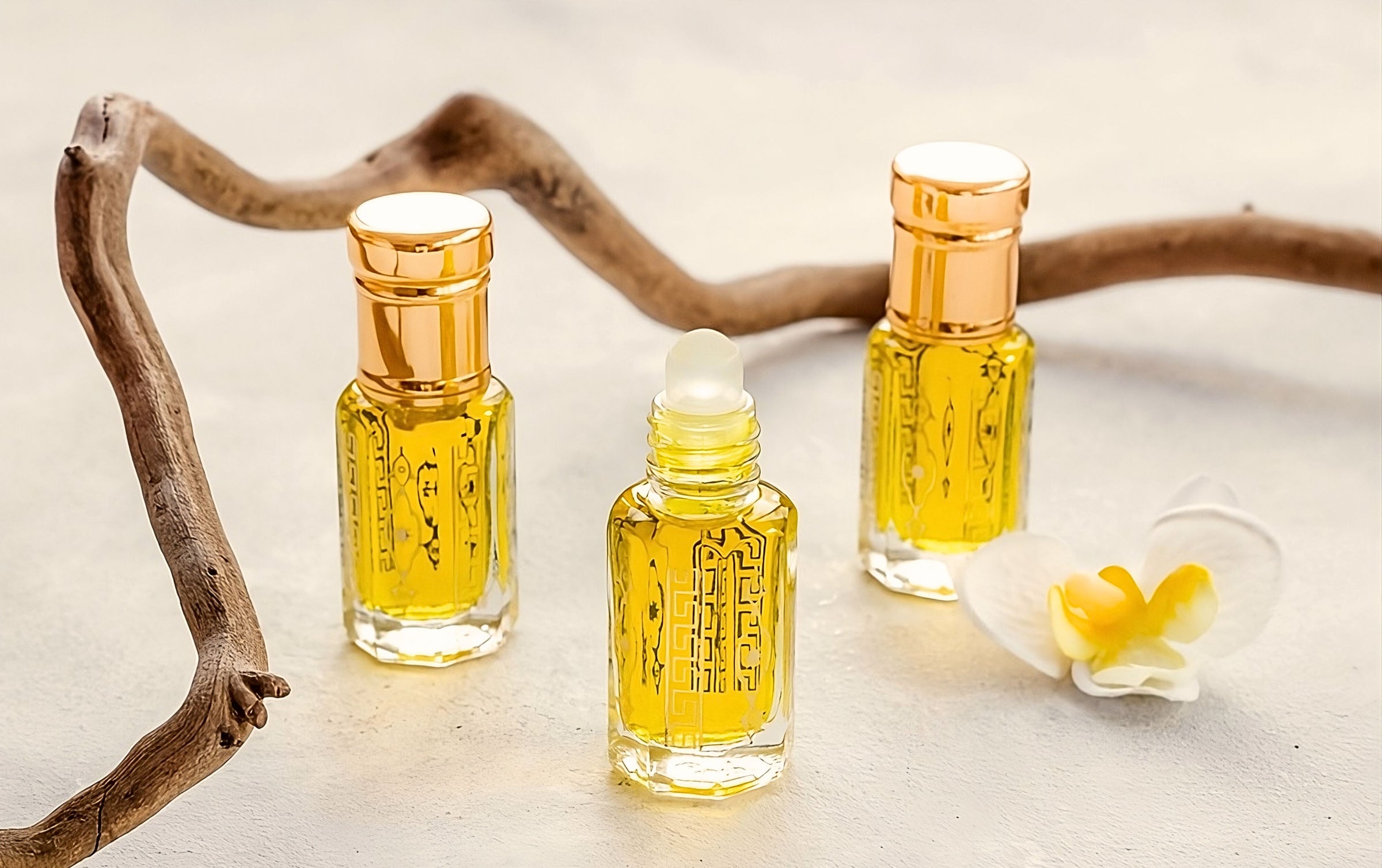 perfume oil bottles beside orchid with behind wood log.
