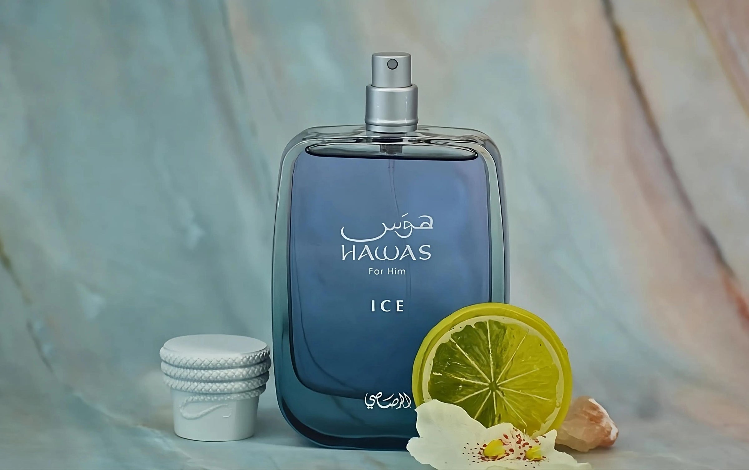 rasasi hawas ice for him perfume bottle with right side labdanum and lemon slice.