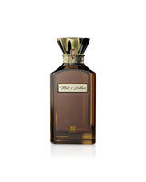 ahmed al maghribi musk and leather Brown perfume bottle with gold cap on a white background