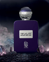 Aksar min oud perfume bottle photograph surrounded with gems with space background