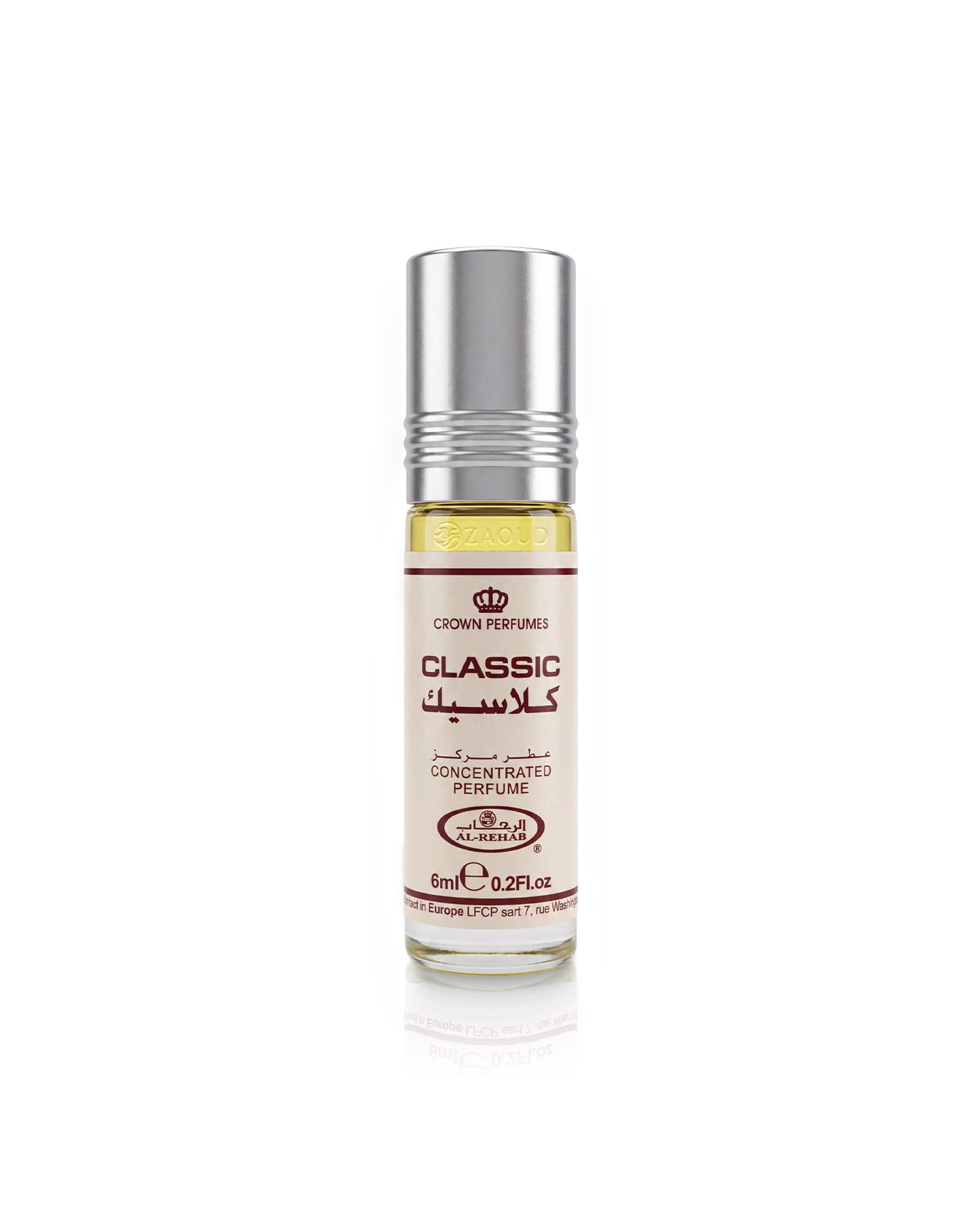 A 6ml roll-on bottle of Crown Perfumes al rehab classic perfume oil, featuring a silver metallic cap and a cream-colored label with red and black text, set against a plain white background with a soft reflection.