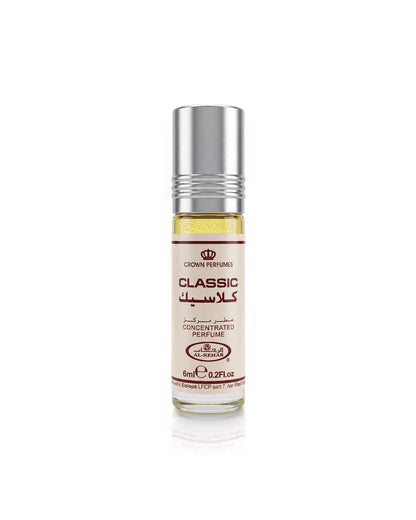 A 6ml roll-on bottle of Crown Perfumes al rehab classic perfume oil, featuring a silver metallic cap and a cream-colored label with red and black text, set against a plain white background with a soft reflection.