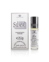 al rehab Silver concentrated perfume roll-on bottle with its white packaging box, featuring black text and a silver cap, on a white reflective background.