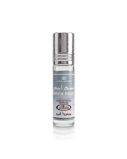 A roll-on perfume bottle labeled 'White Musk' by Crown Perfumes, featuring a silver metallic cap and a white label with gray text, set against a plain white background with a soft reflection below.