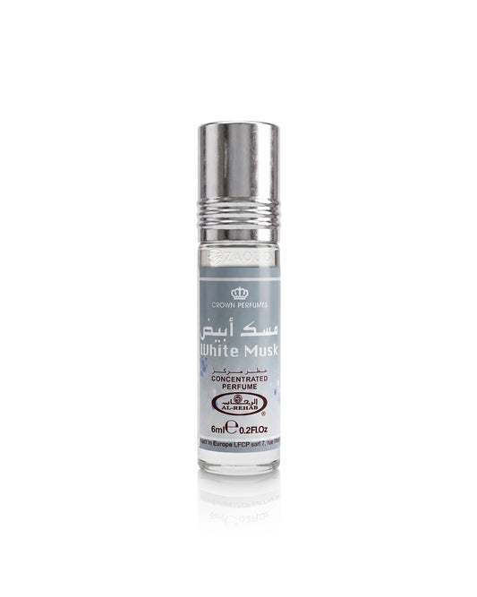 A roll-on perfume bottle labeled 'White Musk' by Crown Perfumes, featuring a silver metallic cap and a white label with gray text, set against a plain white background with a soft reflection below.
