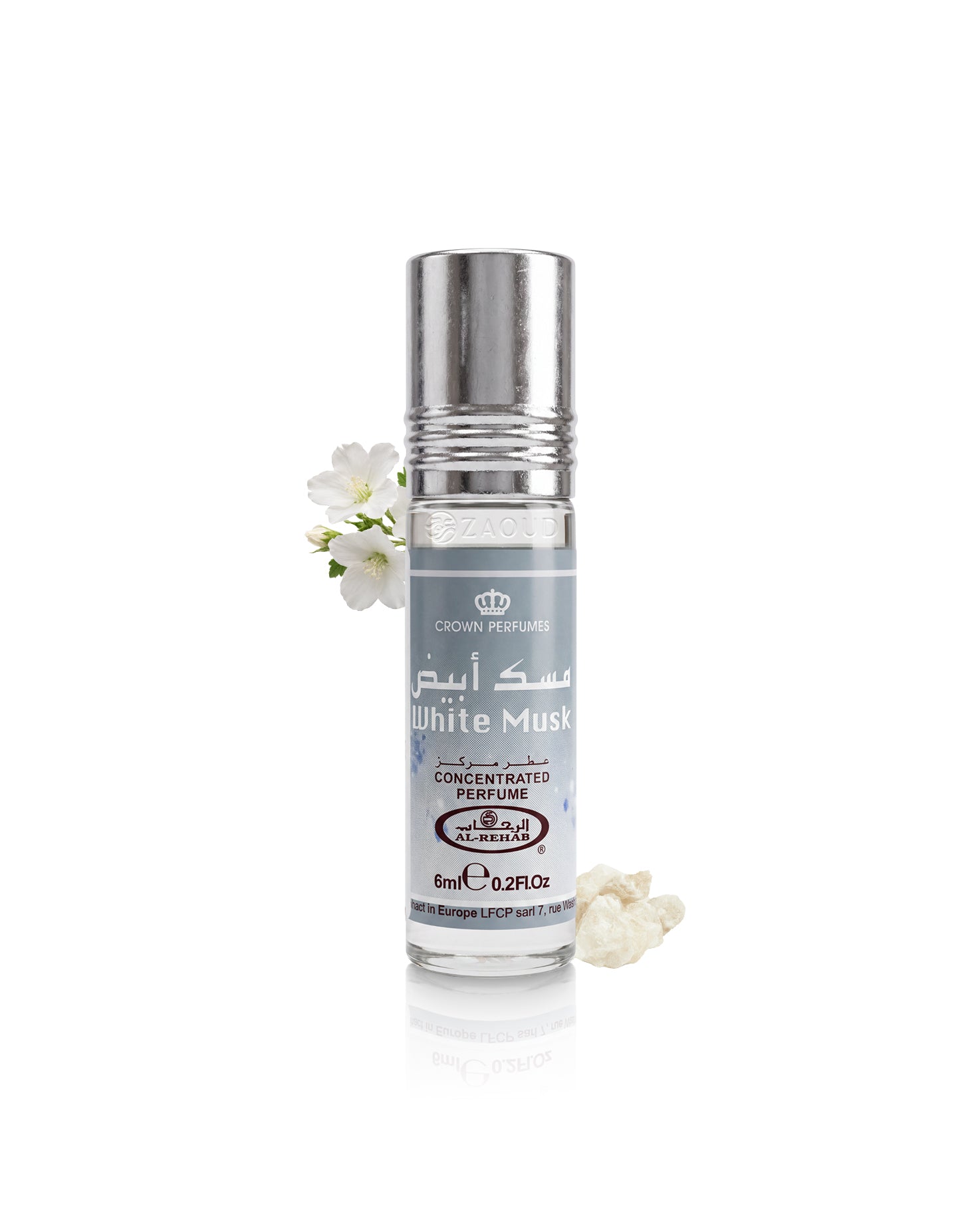 A roll-on perfume bottle labeled 'White Musk' by Crown Perfumes, featuring a silver cap and a gray label, styled with small white flowers on a clean white background.