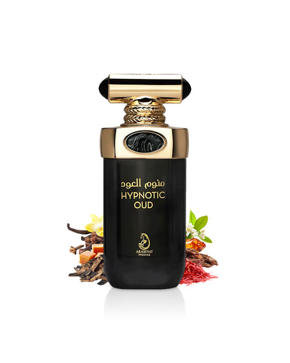 Arabiyat Prestige HYPNOTIC OUD perfume bottle surrounded with fragrance notes like saffron and caramel shows from behind the bottle against white background