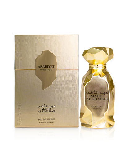 Arabiyat Prestige MAHD AL DHAHAB perfume bottle shows beside its box against white background