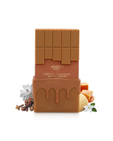 arabiyat sugar toffee ganache perfume bottle surrounded by fragrance notes like cloves and vanilla shows against white background