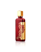 ARD AL ZAAFARAN BAREZ Red and gold perfume bottle with intricate design on a white background