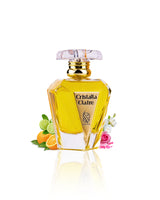 CRISTALLA CLAIRE EDP perfume bottle surrounded by orange musk against white background