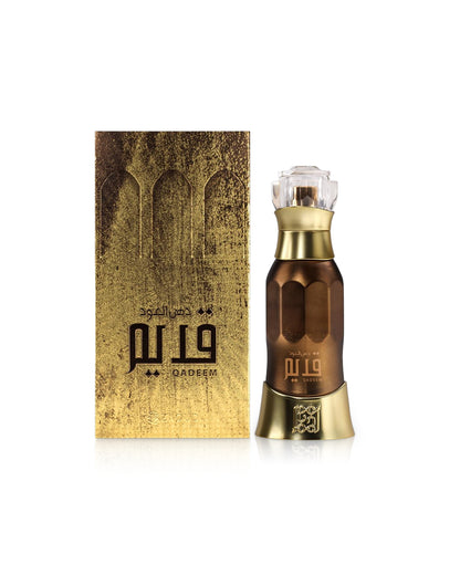 dehn al oud qadeem perfume bottle shows beside its packaging against white background