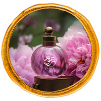 Floral perfume bottle surrounded by pink lily flowers