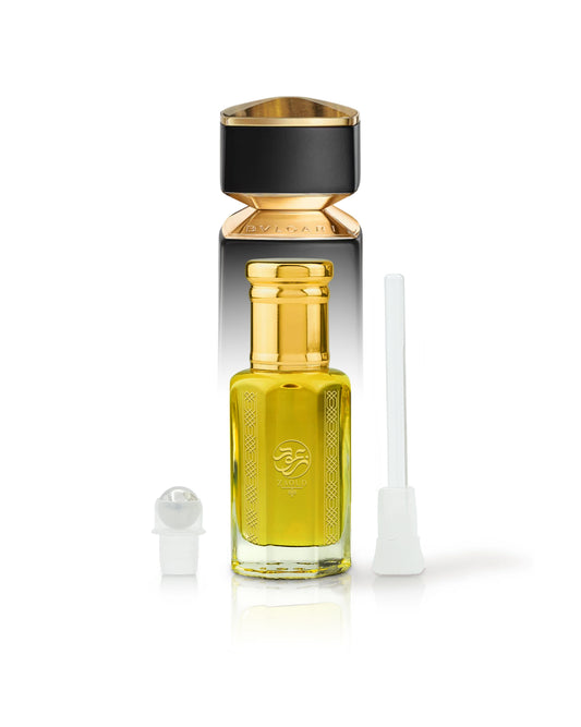 heliodor perfume oil bottle beside roller and stick with Bvlgari tygar behind shows against white background