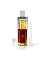 JOSEPHINE perfume oil bottle filled with amber-red liquid, featuring a shiny gold cap and a gold decorative emblem on the front. It is shown with its white atomizer cap off to the left and a white applicator wand to the right, all set against a clean white background.