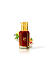 JOSEPHINE perfume oil bottle filled with dark red liquid, featuring a gold cap and gold decorative patterns on the front. The bottle is centered on a white background with small decorative jasmine flowers placed behind it.