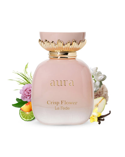 la fede aura crisp flower by khadlaj pink colour perfume bottle surrounded with its ingredients like vanilla and bergamot with many more shows from behind the bottle against white background