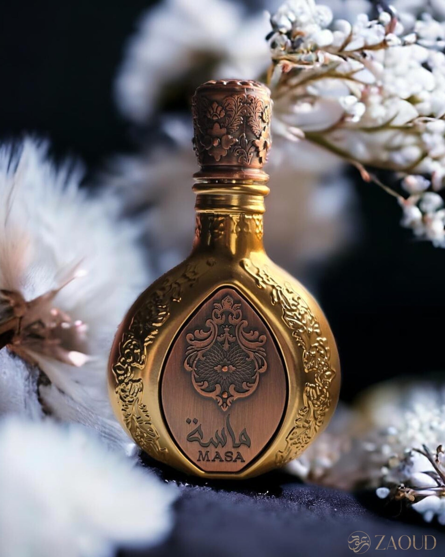 lattafa pride masa perfume bronz bottle photograph surrounded with white flowers and blurry background