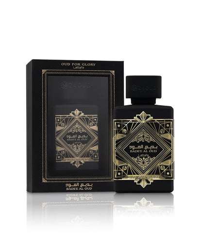 lattafa badee al oud oud for glory perfume bottle shows beside its packaging against white background
