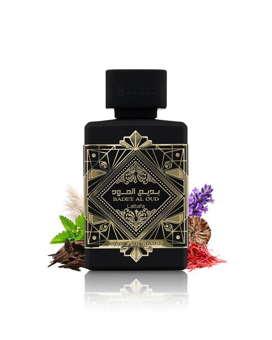 a black perfume bottle with an ornate gold geometric label reading 'BADEE AL OUD' and 'lattafa', styled with botanical ingredients on a white background with a reflection below.