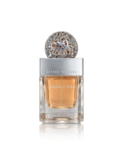 Lattafa Beyond precious perfume bottle with amber liquid, a silver cap, and a decorative silver top, shown on a white background with a reflection.