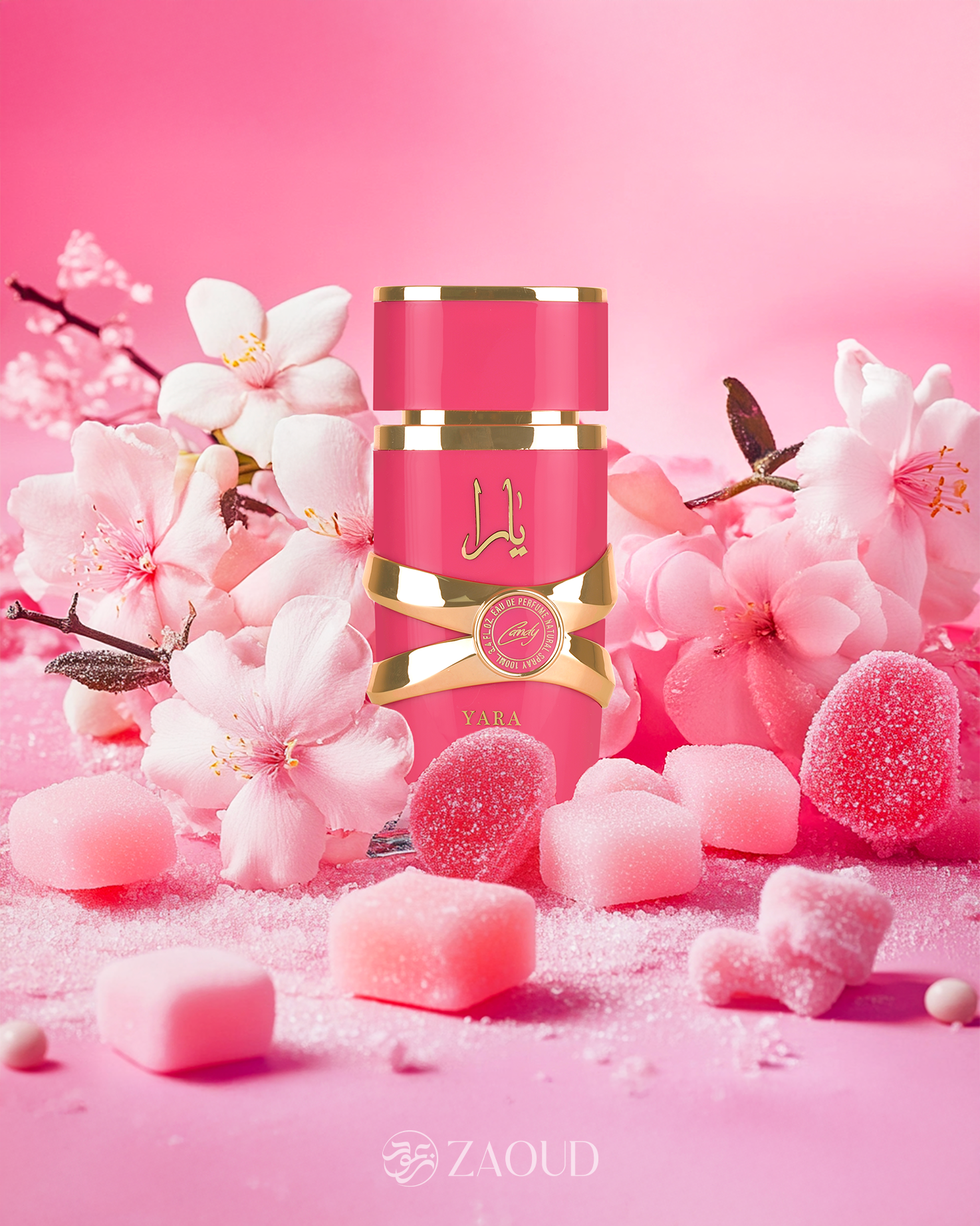 lattafa yara candy perfume pink bottle photograph with surrounding by candy and pink flowers against pink background.