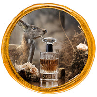 Musk Perfume bottle over reflected surface with a siberian musk deer at background