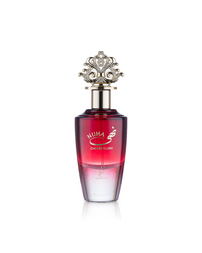 A bottle of Nuha Cherry Blush perfume with a red gradient body, a silver metallic cap, and gold lettering, set against a plain white background.