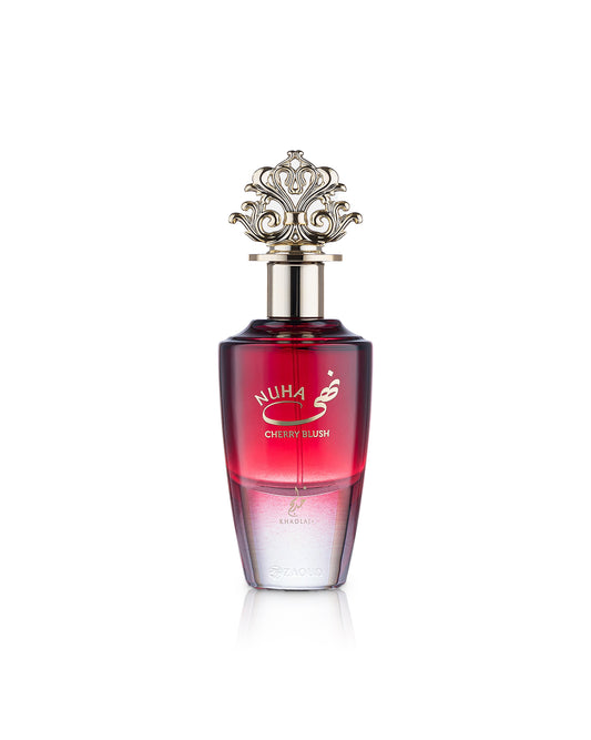 A bottle of Nuha Cherry Blush perfume with a red gradient body, a silver metallic cap, and gold lettering, set against a plain white background.